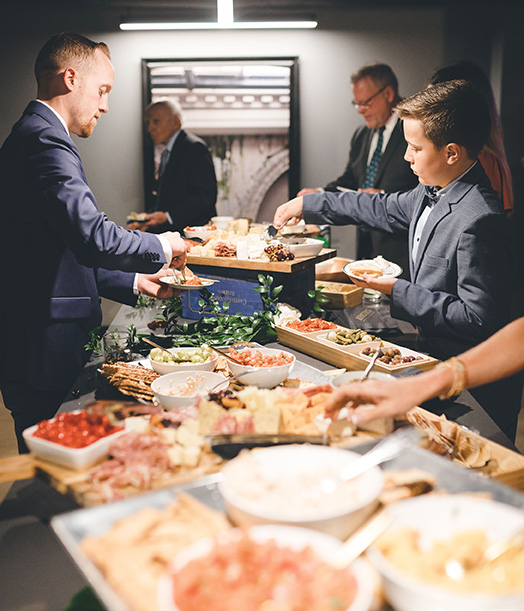 Guests Going Through Hors d'oeuvres Buffet Line